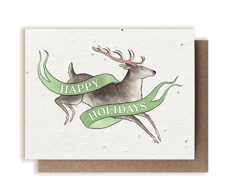 A photo of a plantable seed card with our original illustration with a festive banner and a leaping woodland caribou (Rangifer tarandus caribou), also called a reindeer.